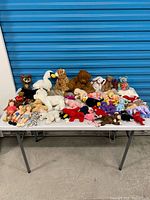 Overall view of entire mixed plush lot on table
