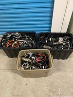Three totes filled with assorted cables and power bars