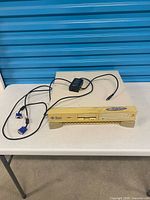 Front view of Sun Ultra 5 workstation with power adapter and VGA cable placed on top