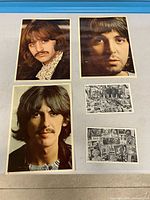Overview showing three colour Beatles portrait prints and two black-and-white collage postcards