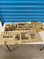 Six loose newspaper sections and comics laid out on table