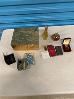 Overview of entire lot on table showing gift box, bottles, carded samples and velvet case