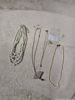 All five jewelry items laid out on surface