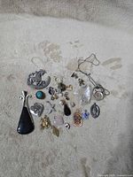 Group view of all pendants and charms laid out on fabric