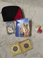 All items together: coin purse, two prints, two yantra cards, three dice