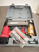 Open case showing Airco nailer, nails packs and air fitting