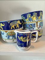 Stacked deep bowls and creamer pitcher showing patterns and colours