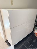 Front view of glossy white 4-door cabinet