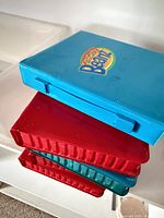 Stack of four Mighty Beanz branded storage cases