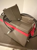 Overall view of projector body with folding arm and attached cables