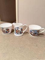 Three-piece tea set showing cup, creamer, sugar bowl and pattern details