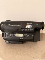 Left side view showing model marking, LCD panel, SteadyShot, 24x zoom label