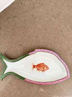 Top view of entire fish-shaped dish showing motif and rim colours
