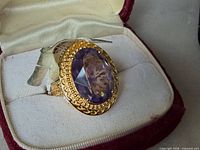 Ring in box showing full setting and stone