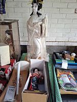 Overall view showing 24-inch doll, display case parts, boxed smaller doll