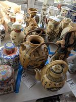 Overall view showing both teapots among other items