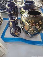 Group of five cobalt blue vases showing sizes and designs