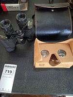 Binoculars with case and Google Cardboard viewer displayed together