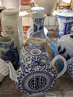 Front view showing pitcher, ginger jar and pair of vases