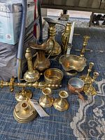 Group of mixed brass and copper items on rug