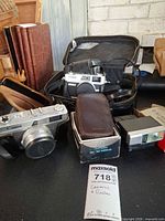 Lot overview showing two Canonet cameras, Ricoh flash box, Canon flash
