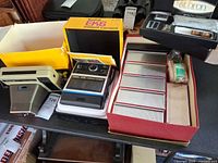 overall lot showing both cameras, slide changer box, bulbs and Yashica item