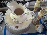 entire group showing pitcher on basin, plates and candlestick