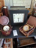 Group view of three boxed clocks