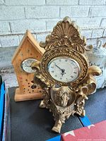 Front view showing both clocks together for scale and style contrast