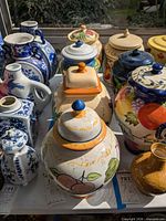 Group view of multiple ceramic jars on table