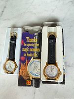 Two watches in holders with Kodak sleeve showing 25th Anniversary graphics