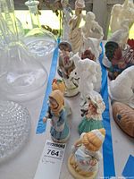 Row of assorted people figurines lined along blue tape