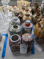 Full group of ginger jars and vases inside blue tape boundary