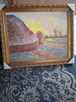 Front view of framed haystack painting