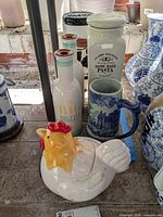Group showing hen cookie jar, pasta jar, drizzle bottle, stein