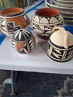 All four pottery pieces grouped on table