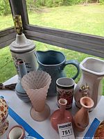 overview of lamp, pitcher, multiple vases on table