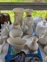 Group of ivory Lenox vases and trinket dish on table