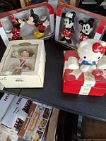 Overall lot showing two boxed salt & pepper sets, Lenox figure box, and Hello Kitty ceramic box