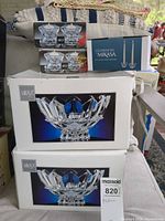 Stacked boxed Mikasa crystal items showing bowls, votives and candlesticks