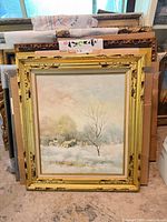 Frontal view of framed winter landscape painting