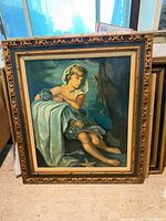 Full view of framed oil painting leaning against wall