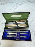 Open Parker 75 case with six assorted Parker pens, and Sheaffer box with two instruments