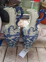Front view of both matching blue and white ceramic pitchers