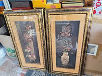 Both framed relief artworks side by side showing overall design and matching frames