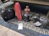 Group view of four stone sculptures on rug