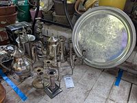 Group shot of tray, teapots, pitcher and assorted candlesticks