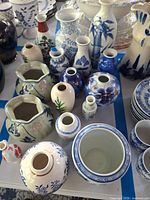 Overview of all seventeen small vases on table