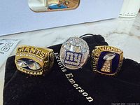 Three NY Giants replica rings on velvet pouch