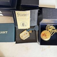 Two boxed Stauer pocket watches with paperwork